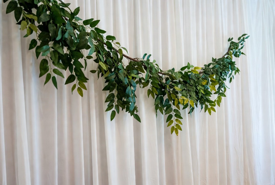 Eucalyptus wedding decor garland styled behind a ceremony backdrop